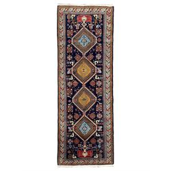 Persian Ardabil indigo ground rug, four interconnected lozenge medallions surrounded by ewer, bird, dragon, camel and geometric motifs, hooked border within guard stripes 
