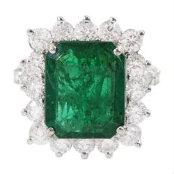  18ct white gold octagonal cut emerald and round brilliant cut diamond cluster ring, with diamond set shoulders, emerald 4.64 carat, total diamond weight 1.80 carat, with World Gemological Institute report