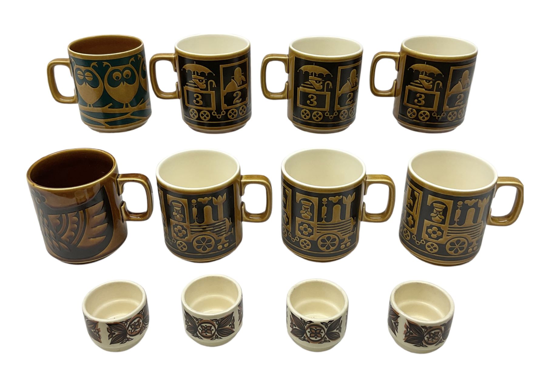 Collection of 1970s Hornsea mugs designed by John Clappison, comprising six Train Robber pattern examples together with owl patterned example on dark teal ground, and further example decorated with stylised hen and chick and egg, approx 9cm, together with four small cup bowls, all with stamped Hornsea marks beneath