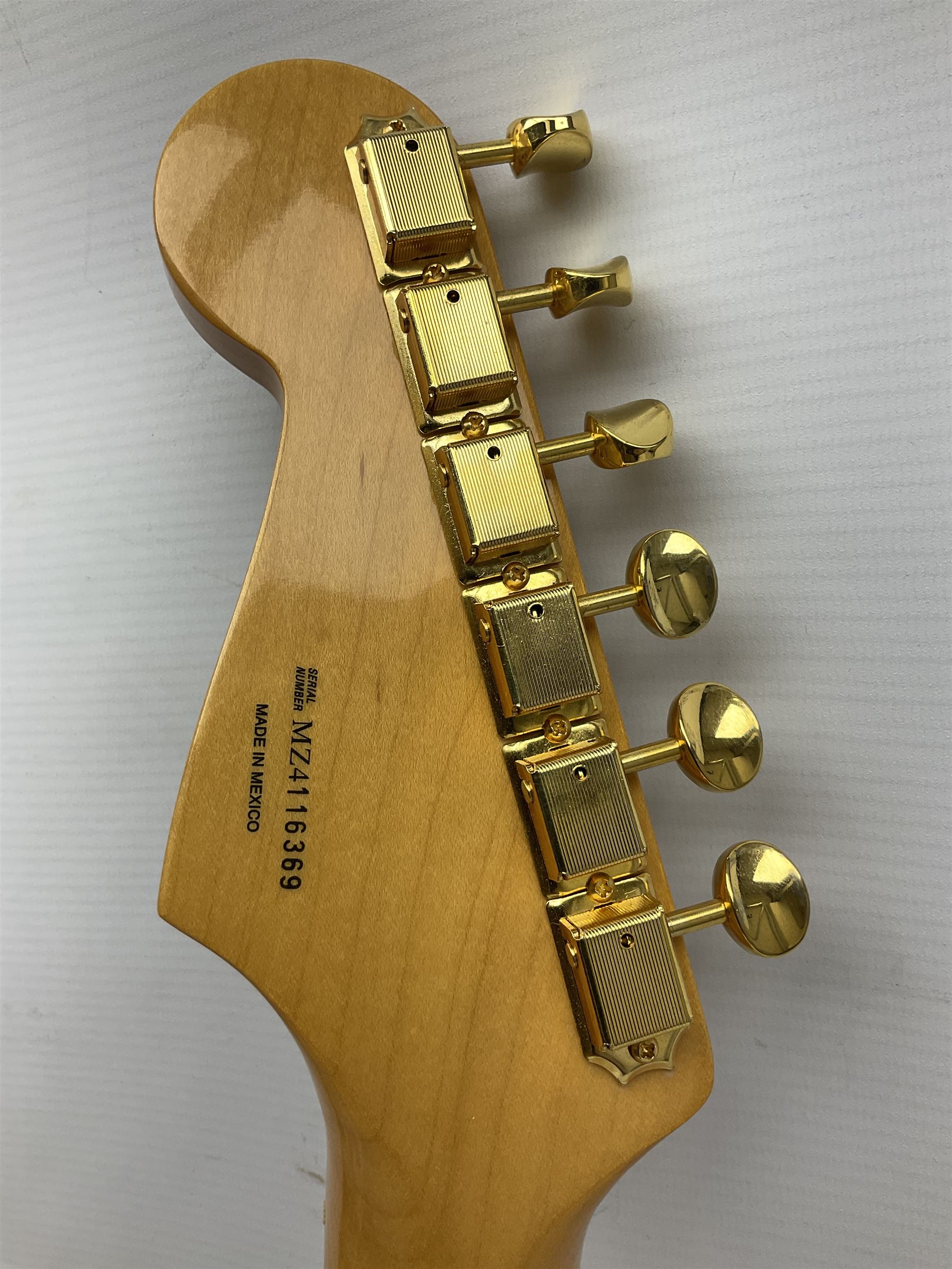 Fender Stratocaster 50th Anniversary 2004 metallic gold electric guitar; serial no.MZ4116369; L98cm; in Spider fitted case with owners manual and other paperwork, strap and belt buckle etc