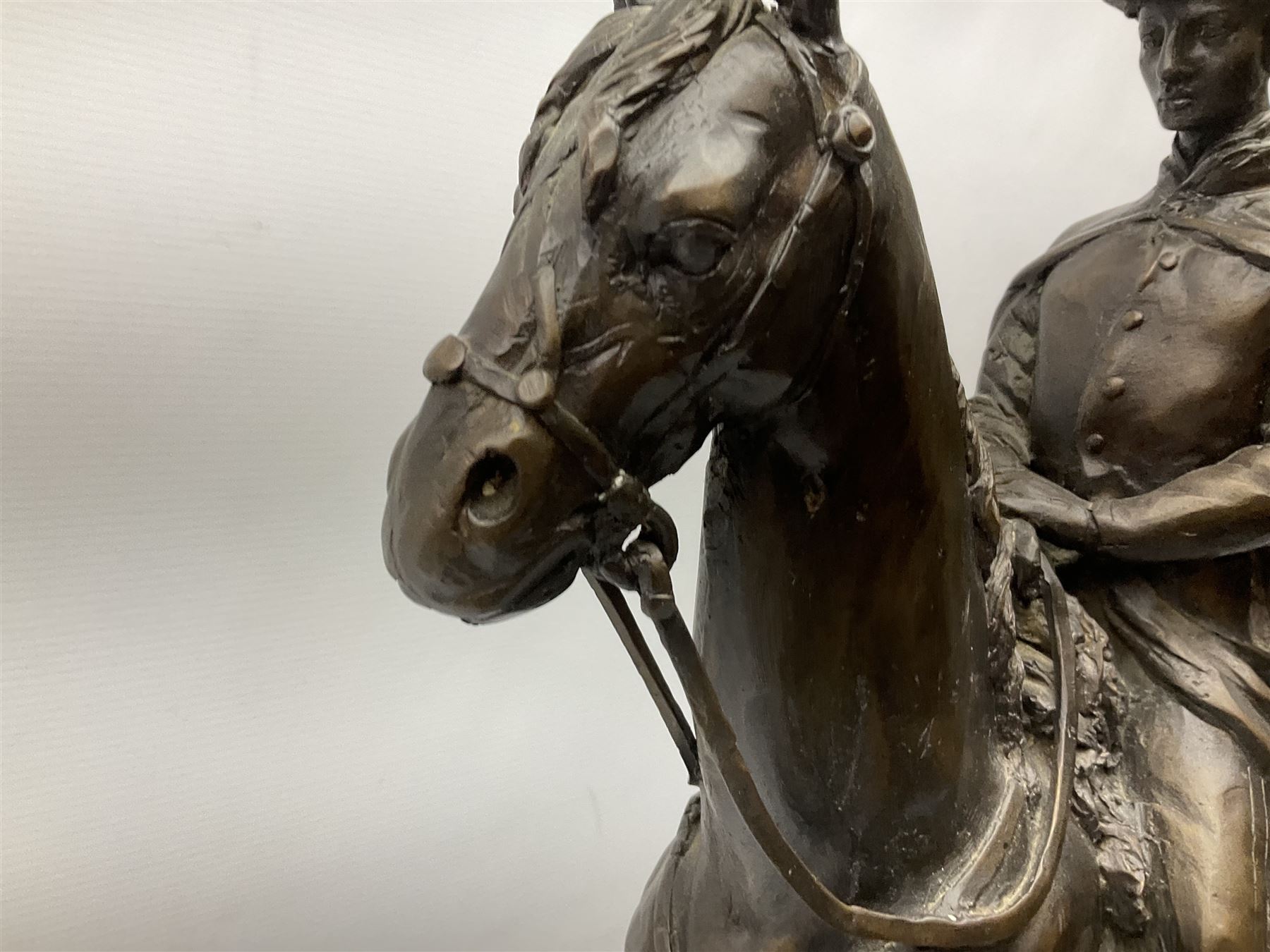 Large and impressive bronze figure of Wellington seated on a horse, on a sarcophogus shaped stepped base impressed 'Meunier Paris', the canted corners inset with battle trophies H68cm L50cm D22cm