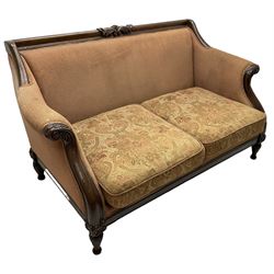 Victorian design mahogany two-seat sofa, the cresting rail carved with foliage scrolls, curved and sweeping arms with acanthus carved terminals, on turned and acanthus carved feet