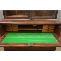  19th century mahogany secretaire bookcase, projecting cornice above two arched glazed door enclosing four shelves, fall front top drawer enclosing fitted interior and green baize, three long drawers below, turned supports, W116cm, H207cm, D59cm  