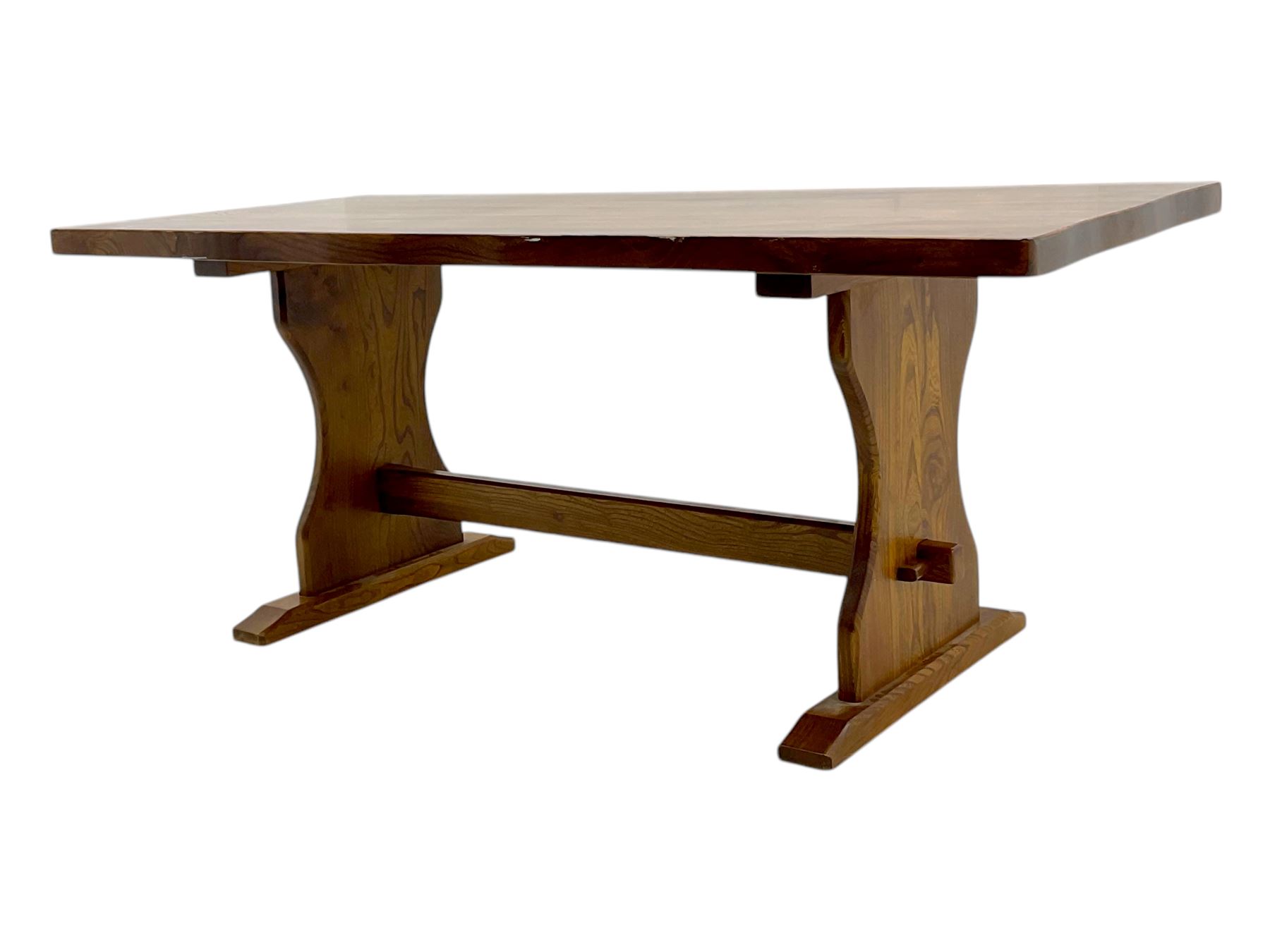 Late 20th century oak trestle table, rectangular top with naturalistic edge, supported by two curved pedestal bases united by central stretcher, on block feet