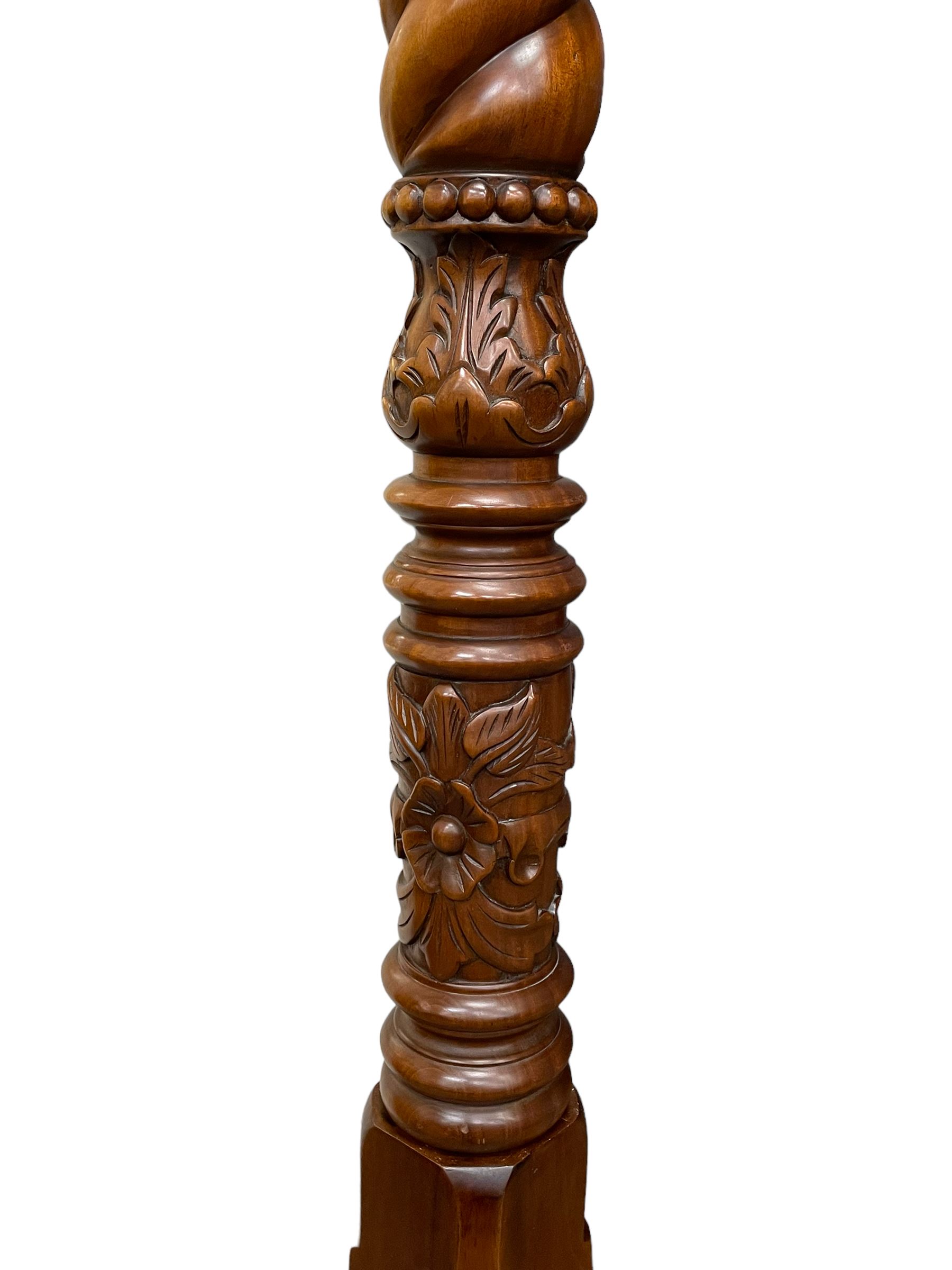 Georgian design mahogany 5' King-size four-poster bed, projecting moulded canopy top on twist-turned columns carved with acanthus leaves and flower heads, the headboard with scrolled broken swan neck pediment carved with scrolled foliage and with central anthemion, on flower head carved ball and claw front feet, with torch and foliate carved pointed finials