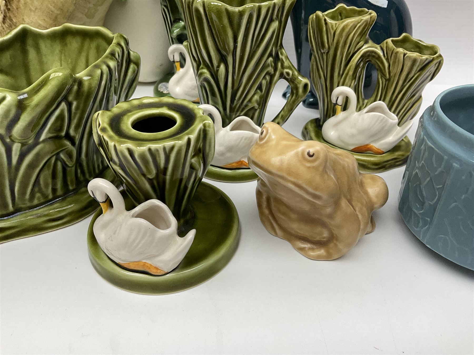 Sylvac budgieregar wall pocket, together with other Sylvac cermics including swan vases, blue tit vase and a frog figure etc, all with printed or impressed marks beneath, and a Poole Pottery cat figure, with printed mark beneath, wall pocket H22cm