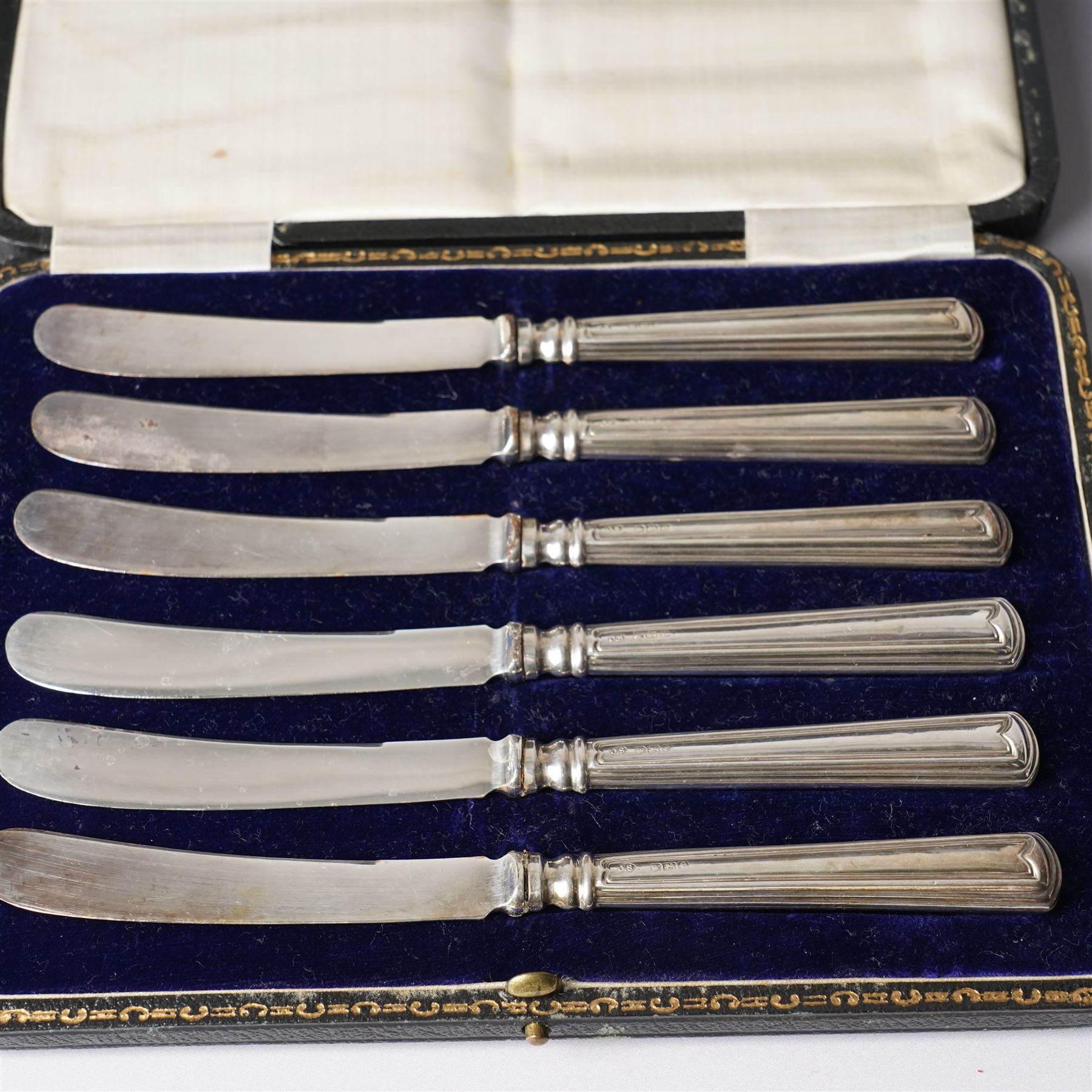 Cased set of twelve silver coffee spoons with bead knop terminals Birmingham 1910 Maker S W Smith & Co and two cases, each containing six silver handled pastry knives