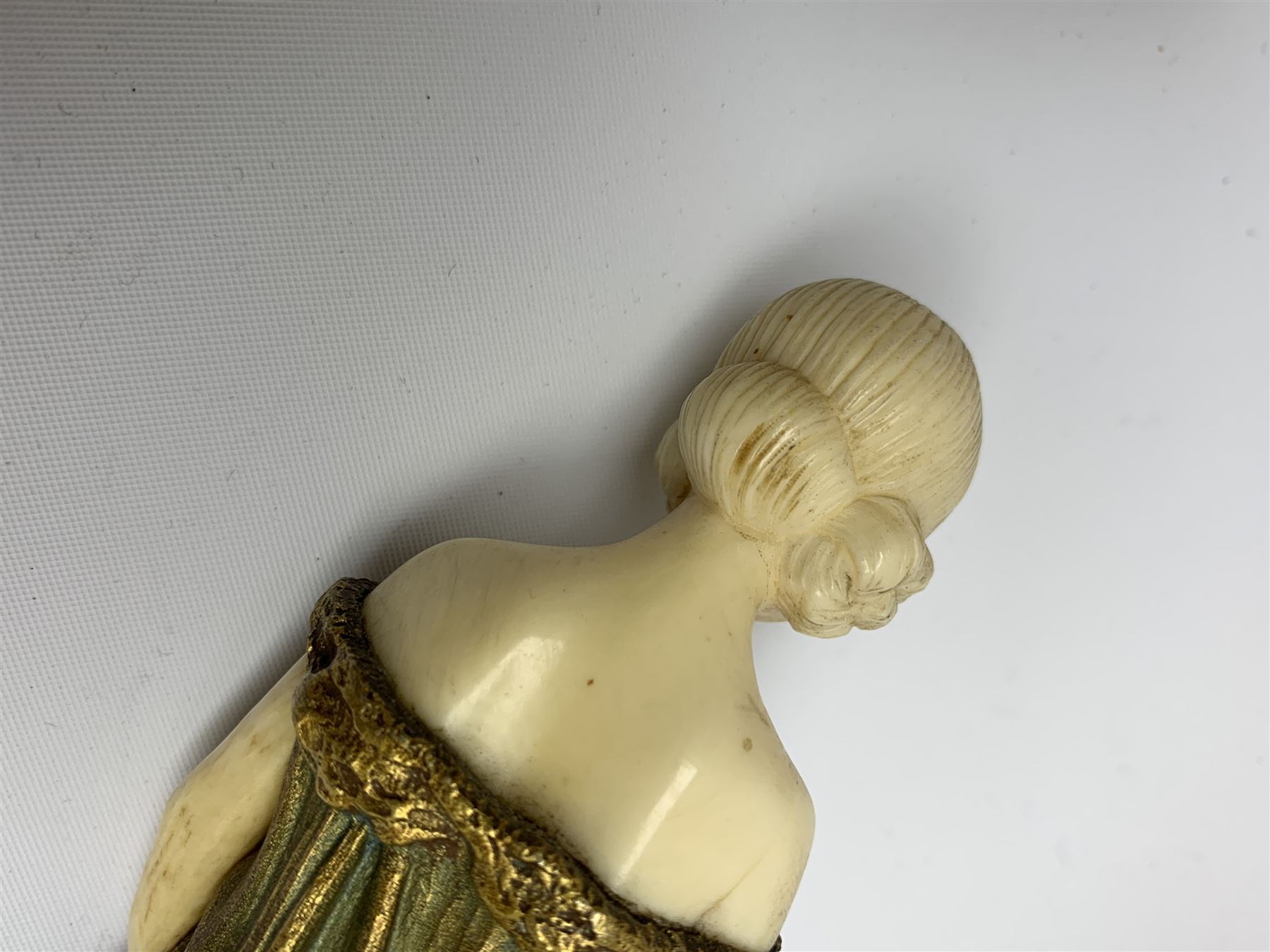 Demetre Chiparus (1886-1947): Innocence, a gilt bronze and ivory figure, circa 1925, standing in contemplative post with hands clasped, upon onyx plinth, signed to base, H24.4cm