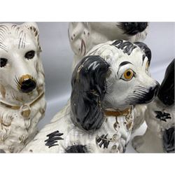 Pair of Staffordshire style dogs, together with two other examples and two cow jugs, largest example H35cm