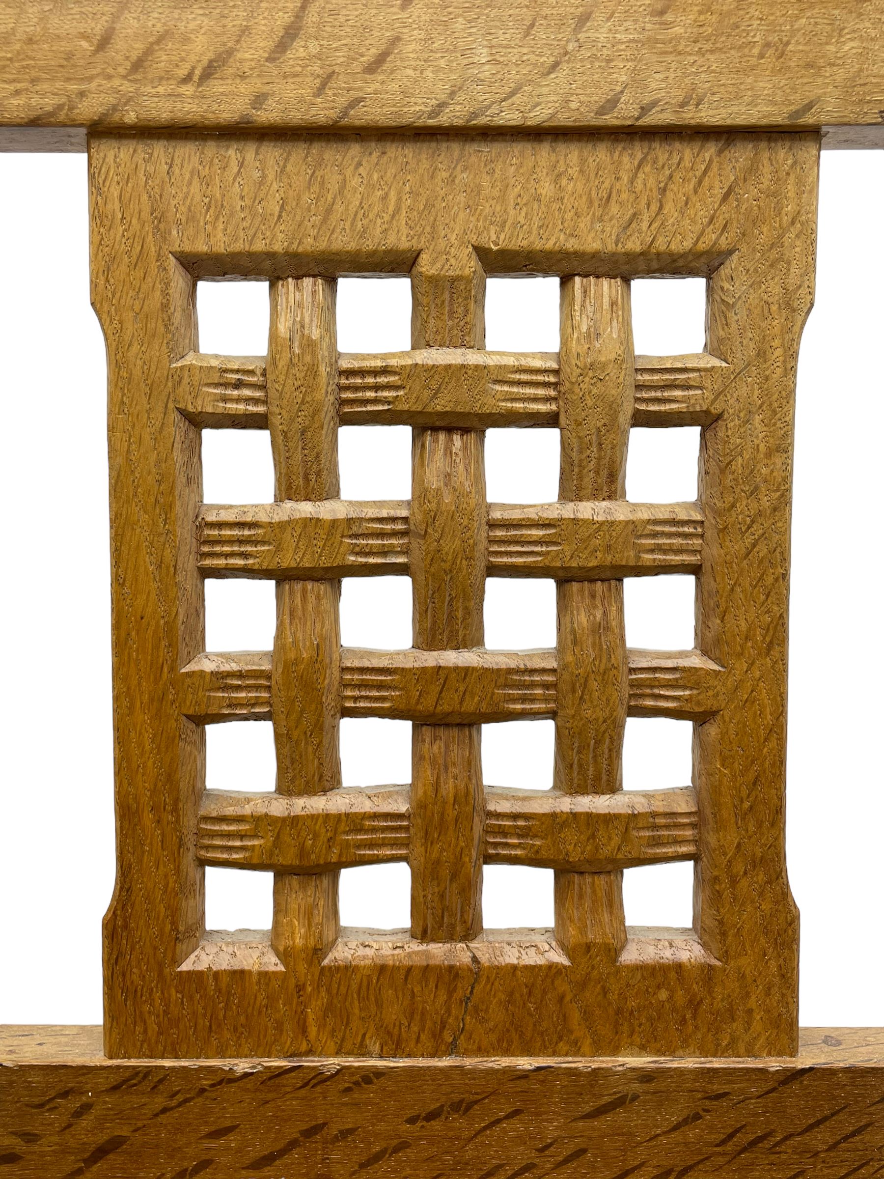 Rabbitman - set of six (4+2) oak dining chairs, carved and pierced lattice back, tan leather upholstered seat with stud band, on octagonal supports united by H-stretchers, carved with rabbit signature, by Peter Heap, Wetwang 