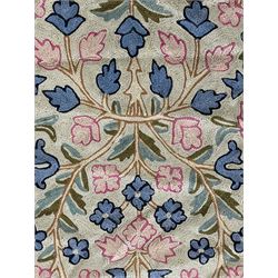 Small pastel prayer rug, cream field with Mihrab arch and trailing floral motifs in pink, blue, and green, bordered by floral patterns, knotted fringe to both ends