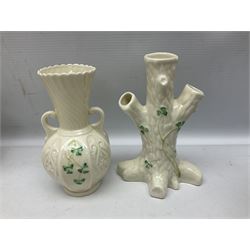 Five late 19th/early 20th century and later Belleek vases, comprising pair of Lotus Blossom examples, shamrock tree trunk vase, twin handled shamrock vase and a baluster form vase decorated with applied roses, all with printed marks beneath, tallest H16cm