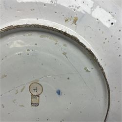 Early 18th century Delft marriage plate, of circular form with dished centre, the centre inscribed and dated 'Thomas and Elizabeth Kockerill Bridlington Key 1715' within a crowned C scroll cartouche, flanked by demi-griffins, above a putto head and tassels, within a wide foliate border, D34cm
