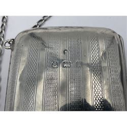Early 20th century silver mounted coin purse, with leather interior and finger chain, hallmarked Samuel M Levi, Birmingham 1917, together with a similar Edwardian example, with engraved initials and engine turned decoration, hallmarked Birmingham 1907, maker's mark worn and indistinct, largest W11.3cm