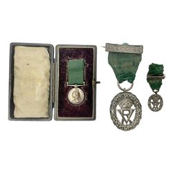 Victoria Volunteer Officers’ Decoration, V.R. cypher, hallmarked silver London 1892, with integral top riband bar and ribbon, unnamed; the matching miniature; and Victoria 'For Long Service in the Volunteer Force' miniature medal with ribbon in original case (3)