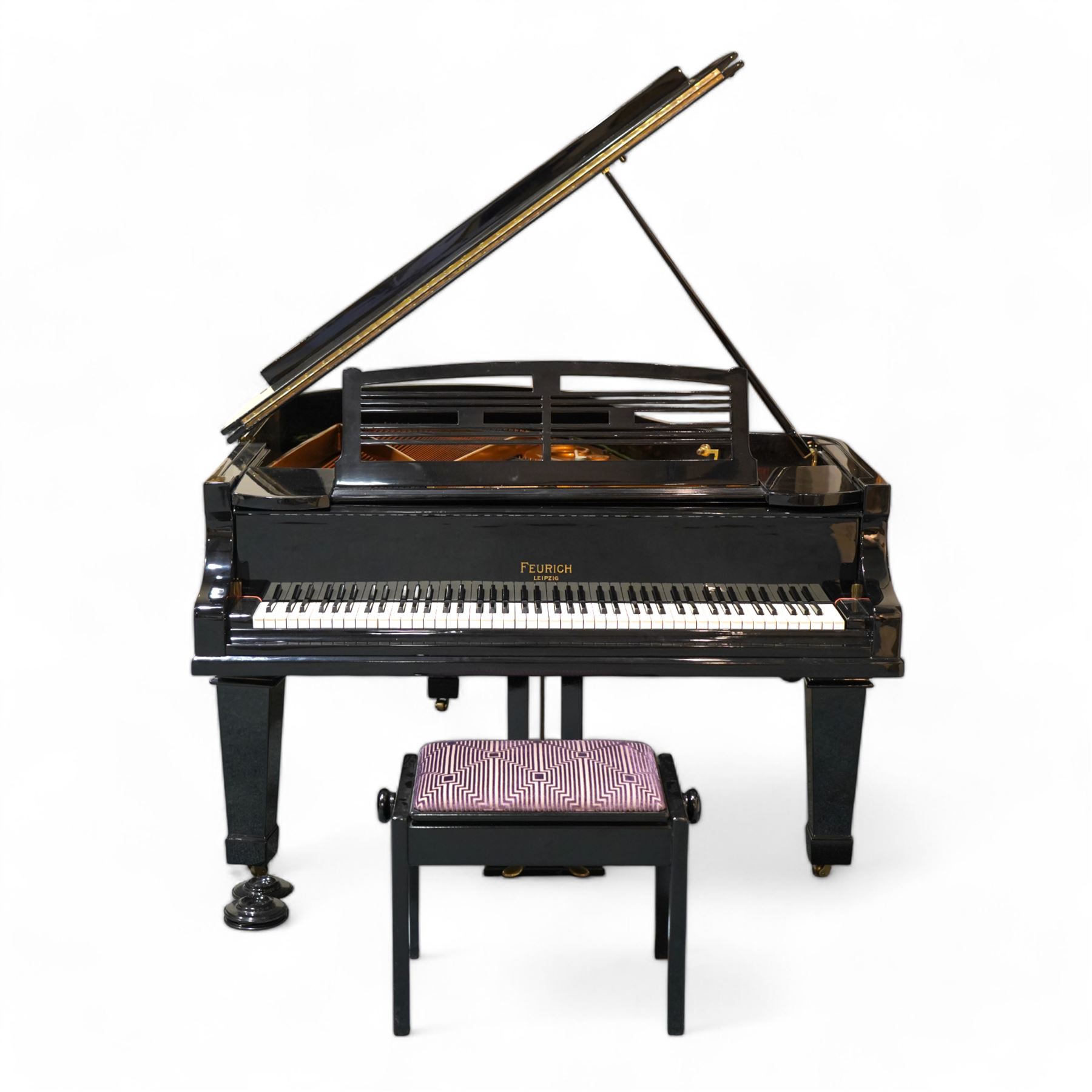 Feurich of Leipzig - German overstrung medium grand piano in a black lacquered case, with a seven octave M&K of Leipzig roller action keyboard, original strings and tuning pins, new hammer heads and dampers, with sostenuto and sustain pedals, adjustable music desk and matching adjustable stool.