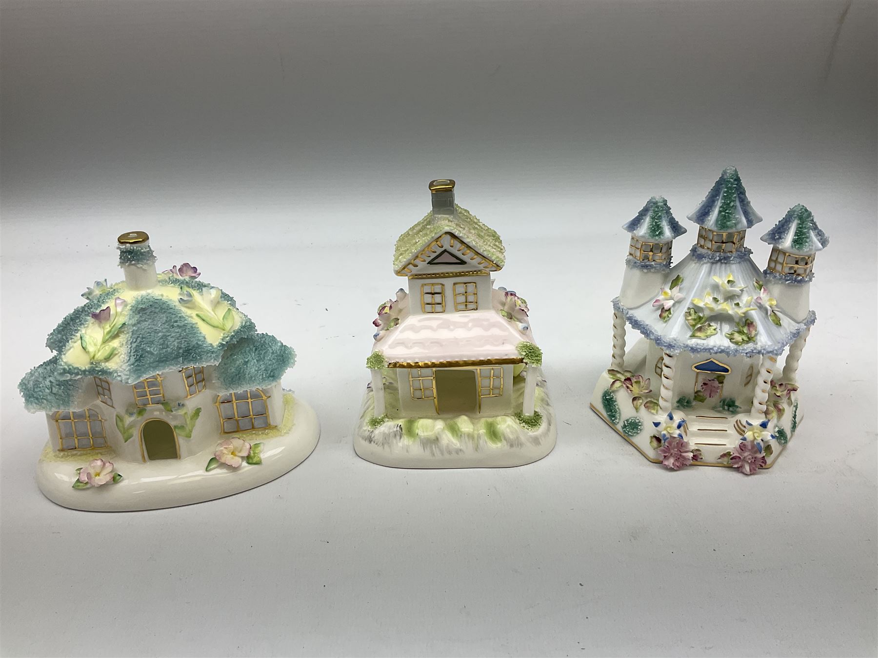 Twelve Coalport bone china pastille burner cottages, to include Fortune Towers, Summer Palace, The Vinery, Springtime Cottage, Dream Villa, Half Moon House, etc, all with original boxes and some with certificates 
