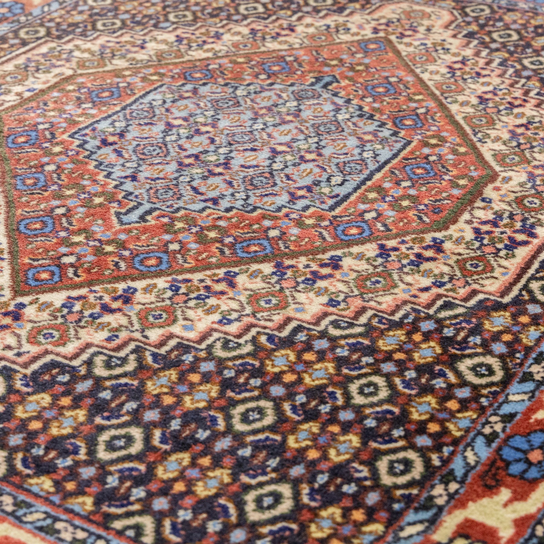 Persian Bijar prayer rug, dark brown ground with all-over Herati design surrounding a rust and pale blue central medallion, cream inner border and rust floral outer border