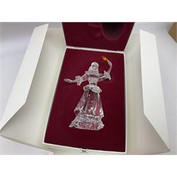 Swarovski Crystal Masquerade trilogy; 1999 Masquerade Pierrot, 2000 Columbine, 2001 Harlequin all with accompanying plaque, stand and original box, together with a glass display case with mirrored back and sides 