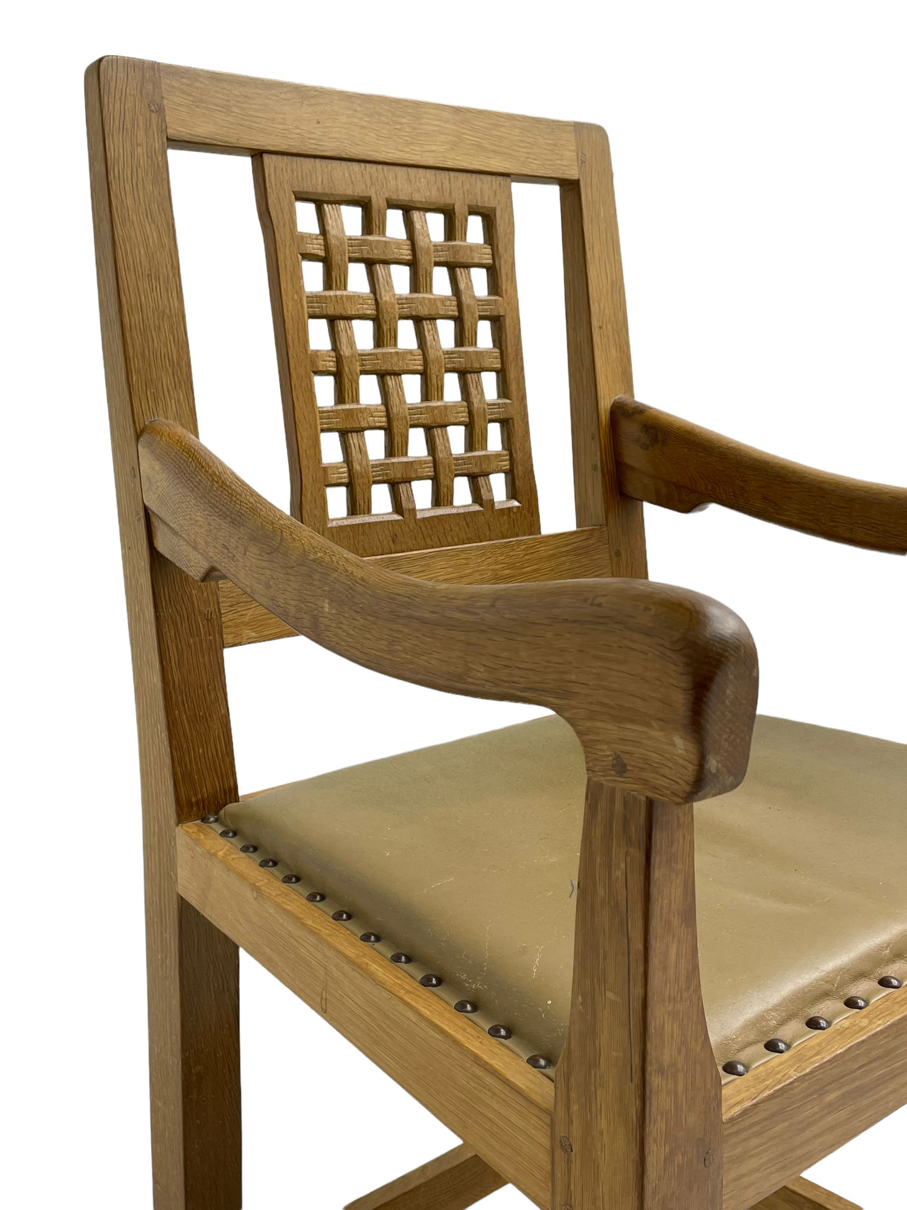 'Rabbitman' set of eight oak dining chairs, pierced lattice backs, upholstered seats with studwork band, octagonal front supports joined by stretchers, carved with rabbit signature, two carvers and six side chairs, by Peter Heap of Wetwang