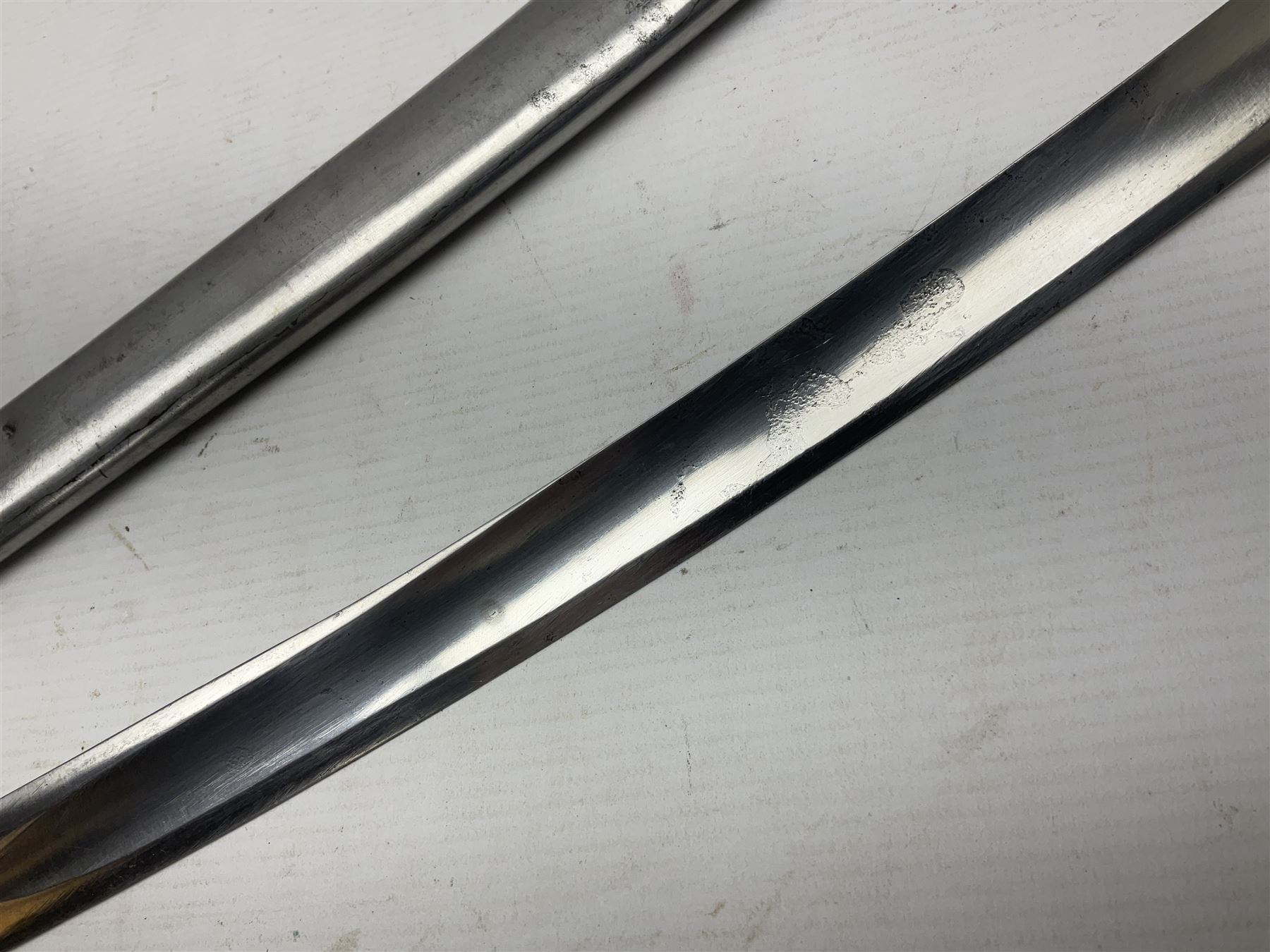 Early 19th century French Lancers officer's sword c1810, the 84cm curving fullered blade retaining most of its bluing, gilding and engraved decoration, inscribed I.S.& C. to ricasso (for Schimelbusch), brass three-bar hilt with elongated elliptical langets and wire-bound leather grip; in polished steel scabbard with two brass suspension rings L100cm overall