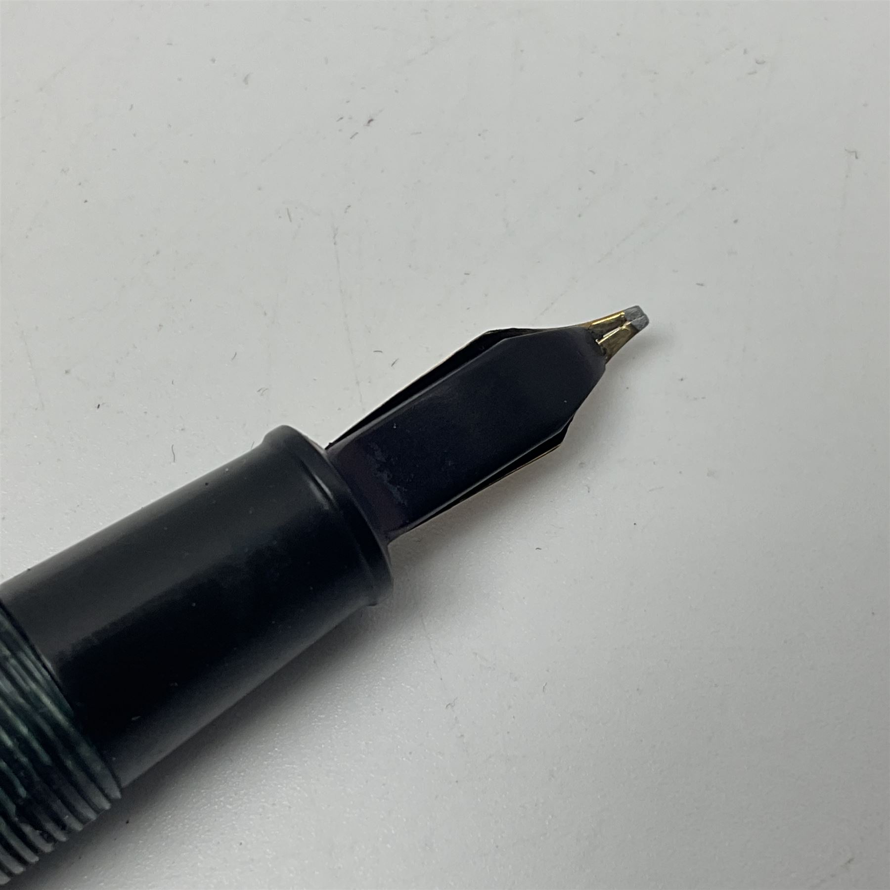 Four fountain pens, each with 14ct gold nibs, comprising Mentmore Paramount, Parker Junior Duofold, Conway Stewart marbleised pen and Waterman's, together with a 14ct gold Conway Stewart 5B nib