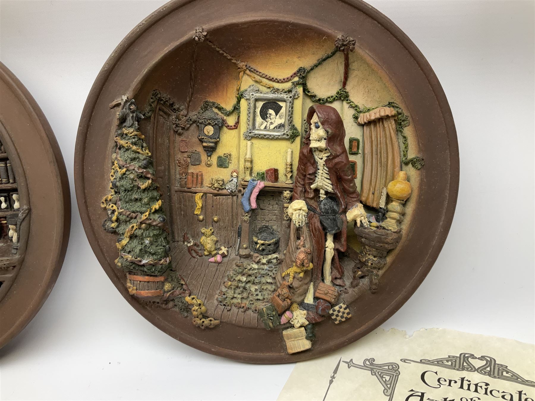Two Terry Pratchett Discworld limited edition sculptured bas-reliefs, designed by Clarecraft, comprising Death Study created by 'the cunning artificer, Bernard the stout', 132/500 and The Hogfather, created by 'the cunning artificer, Bernard the stout', 132/500, both with certificates of authenticity.   