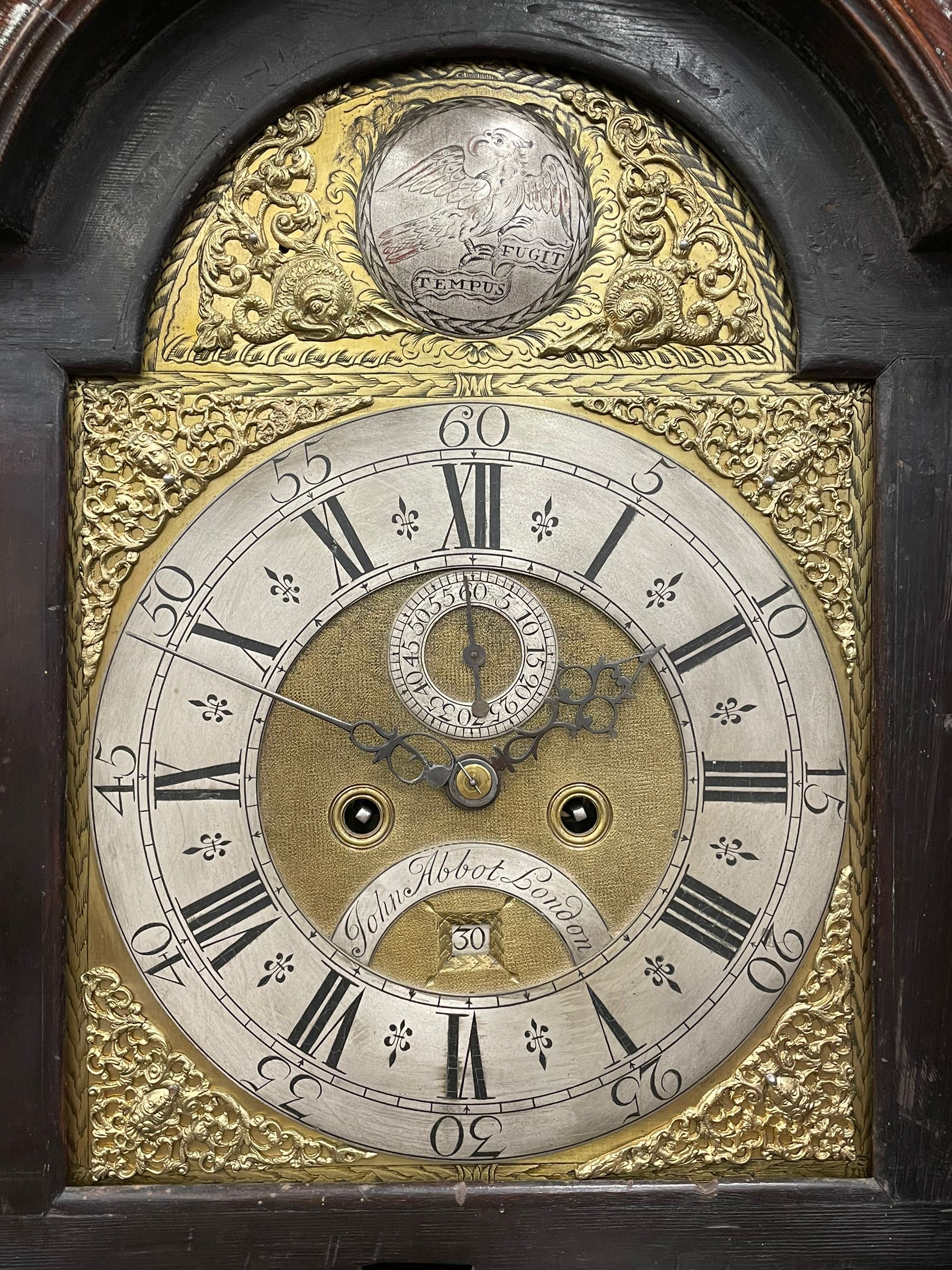 John Abbot of London – early 18th century walnut 8-day longcase clock c1740, hood with glazed side panels and tall swept pagoda pediment above a break arch hood door with attached pillars and gesso wooden capitals, long trunk door with a conforming break arch top on a rectangular plinth with applied shaped skirting, brass dial with a matted center and continuous herringbone engraving to the surround, cast spandrels, silvered chapter with Roman numerals, five minute Arabic’s, minute track and inner quarter hour track, subsidiary seconds dial and square date aperture, silvered tempus fugit boss to the break arch, dial pinned directly to a rack striking movement, striking the hours on a bell. With weights and pendulum.