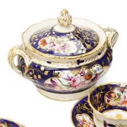 Collection of early 19th century Coalport pattern tea ware decorated with panels of flowers within a blue and gilt surround comprising eight tea cups, three coffee cups, eight saucers, four large plates, two handled sucrier and cover, milk jug and slop bowl and a similar small dish with loop handle