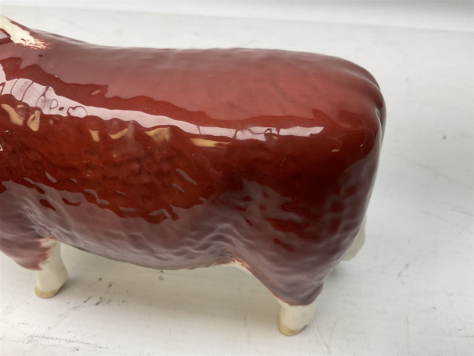 Three Beswick models comprising Hereford Bull no 949, 'CH Cutmil Cupie' Pug, and bay Shire horse, all with printed marks beneath