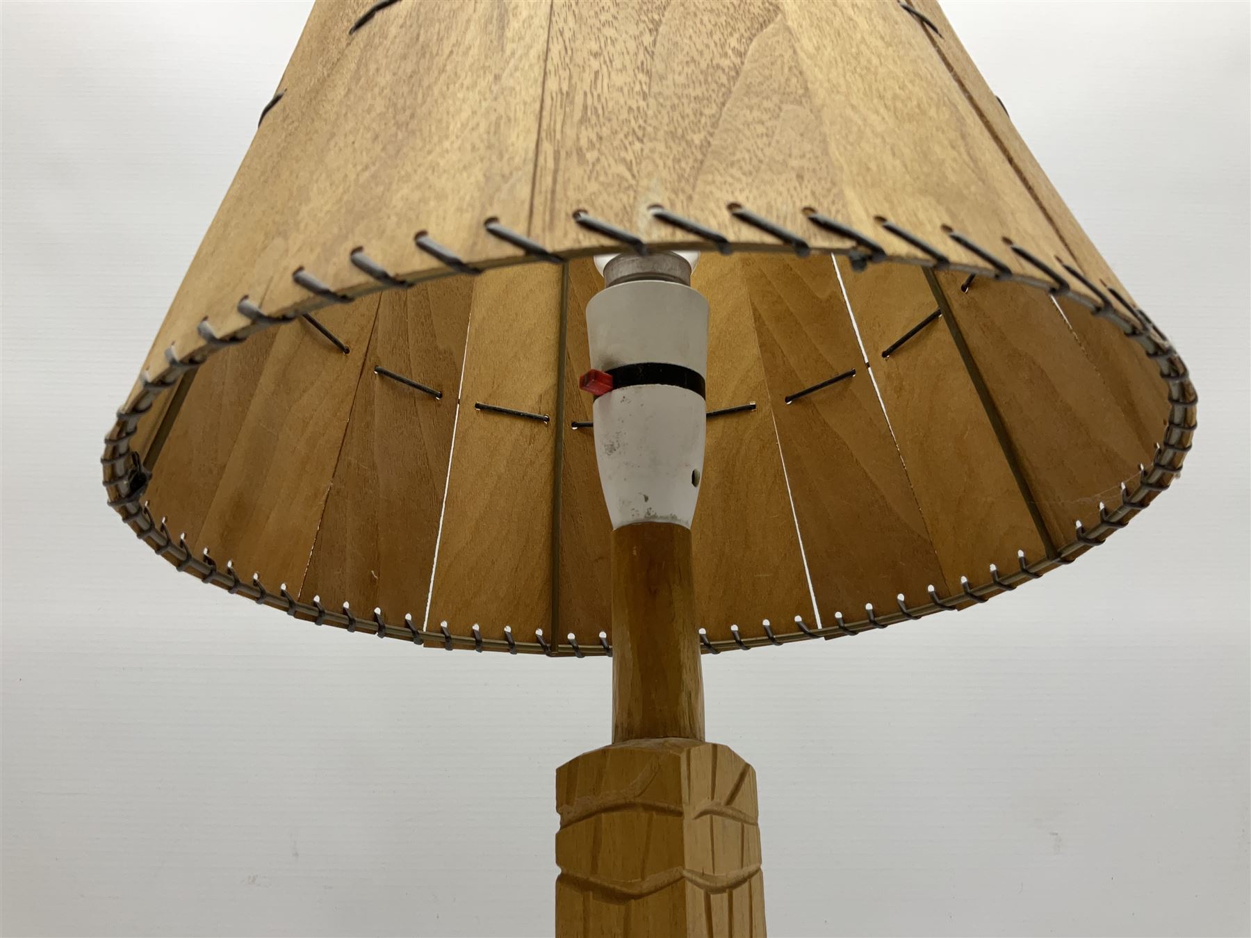 Mid 20th century Paul Caron carved table lamp, modelled as man standing before an oven, the chimney supporting the panelled shade, the base signed P.E. Caron, H42cm