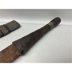 Omani presentation sword kattara, with 77cm  broad slightly curved single edge blade with two fullers, leather bound hilt woven with silver wire decoration and iron pommel;  in tooled leather scabbard with chased silver mounts and presentation plaque 'To Capt. D.M. Naylor From C Company NFR Oman Dec 1962' (Northern Frontier Regiment) L99cm overall