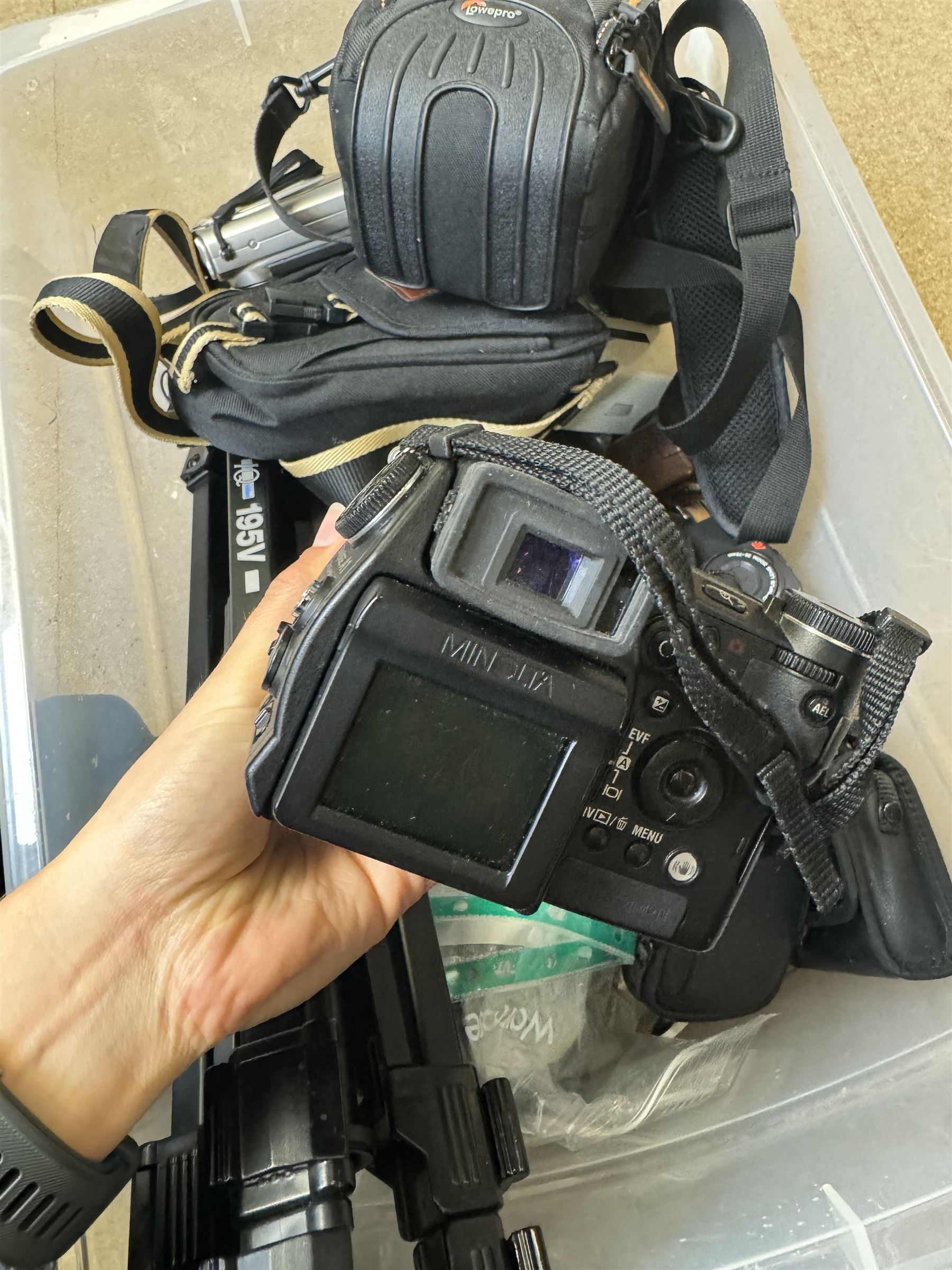 Collection of cameras and camera equipment, including Voigtlander Vitomatic I, Nikon Coolpix P340, Nikon Coolpix S9100, Olympus SP-510UZ, tripod, cases, etc