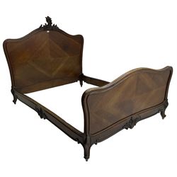 Early 20th century French walnut 4' 6'' double bedstead, the headboard with moulded frame carved with C-scroll shell decorated with foliage, on foliage carved cabriole feet with scrolled terminals