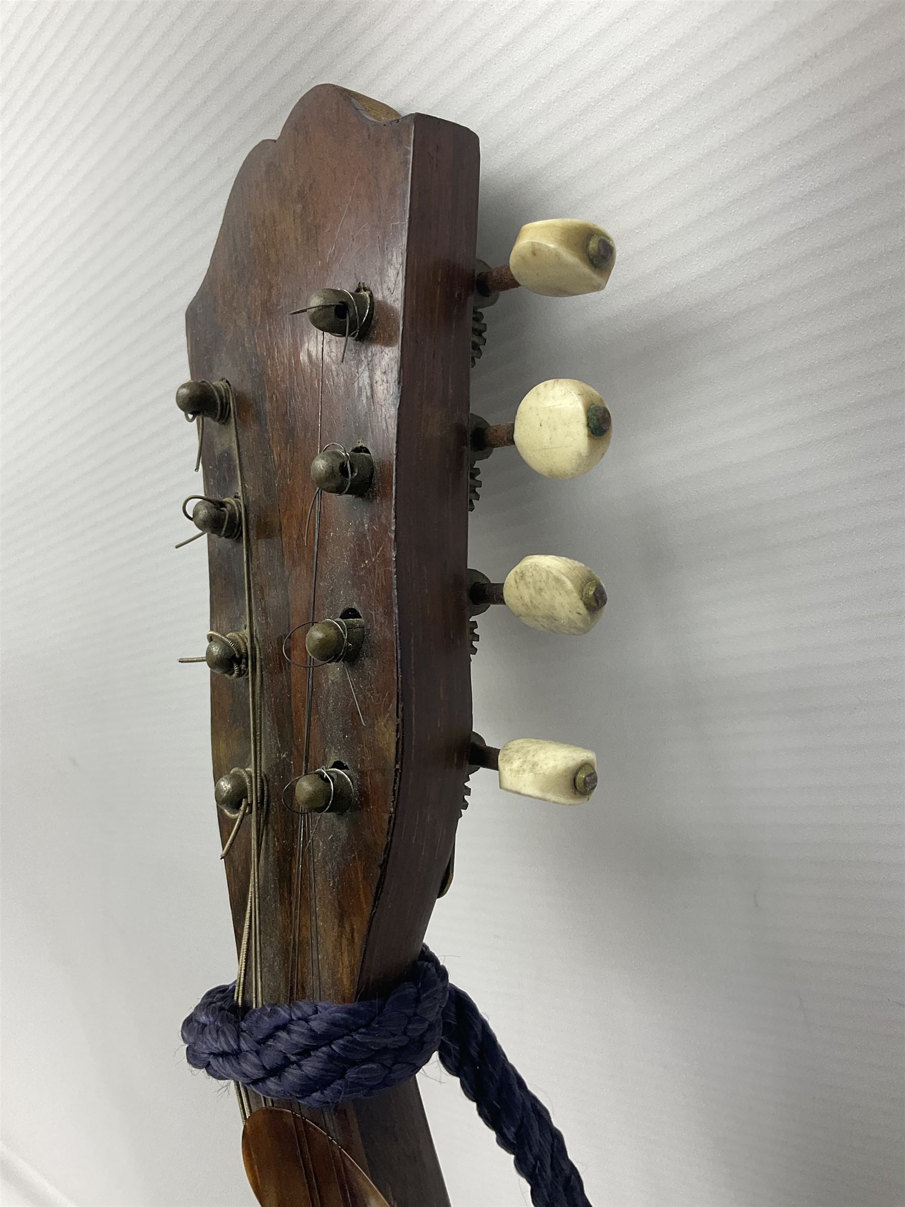 Late 19th/early 20th century Italian lute back mandolin with segmented back and spruce top; bears maker's label for Pietro Tonelli Napoli; together with a mandolin instruction booklet and a folding music stand L60.5cm