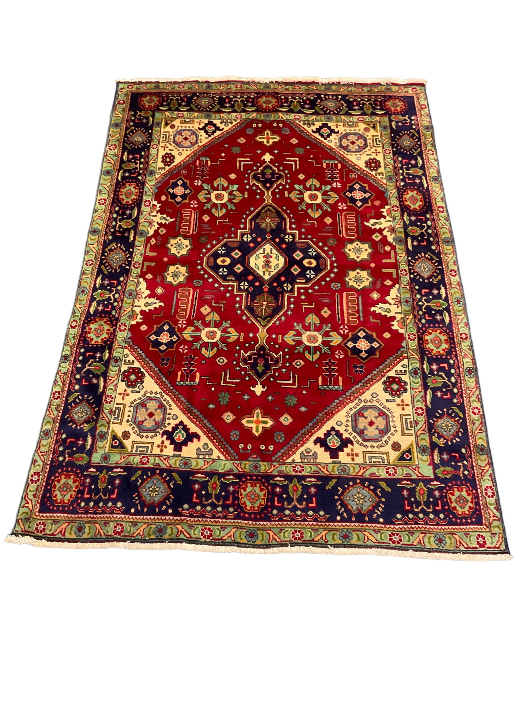 Qashqai red and blue ground rug, with central medallion, green repeating border with geometric motifs 