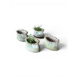 Four cast stone garden planters in the form of ribbon tied planting sacks