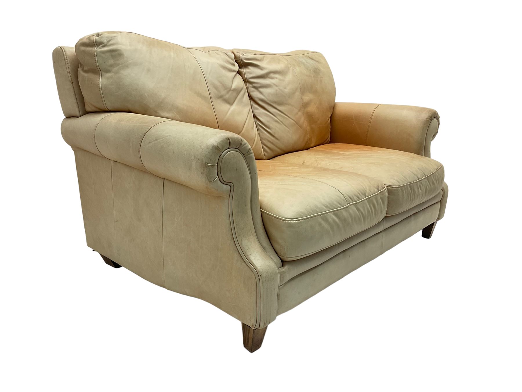 Two seat sofa, upholstered in pale tan leather with scrolled arms ...