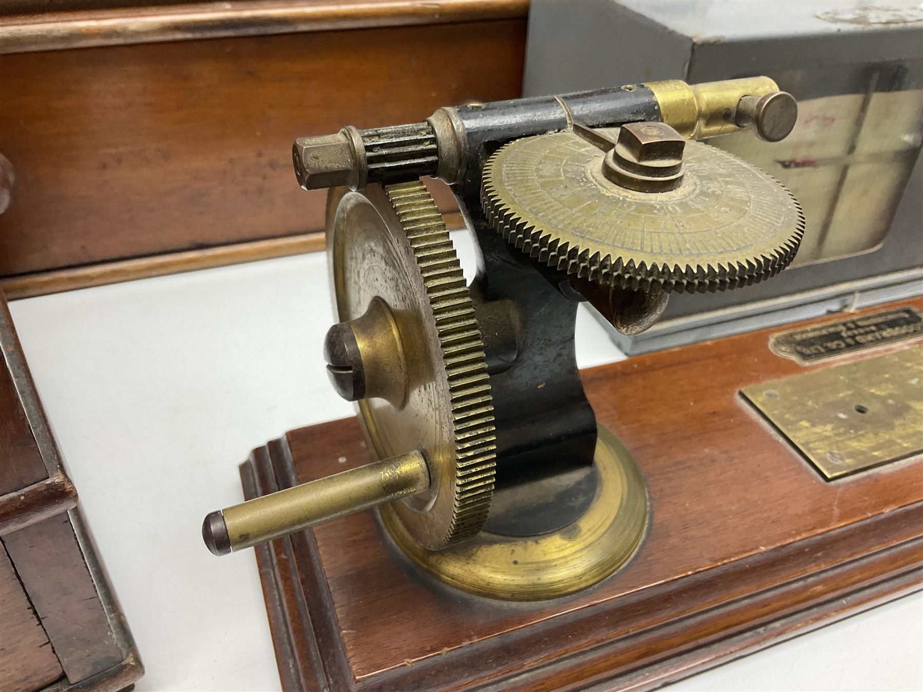 Collection of textile equipment, comprising, Goodbrand & Co. mahogany and brass yarn tester, Negretti & Zambra barograph and two sets of precision scales
