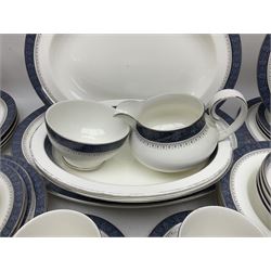 Royal Doulton Sherbrooke pattern dinner service, comprising two oval serving platters, two oval serving dishes, five dinner plates, six dessert plates, two side plates, six soup bowls, four smaller bowls, one large saucer, six smaller saucers, six teacups, open sucrier, milk jug, and cream jug