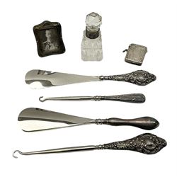 Group of silver to include foliate engraved vesta case with gilt interior by John Rose of Birmingham, stamped J R, two silver handled button hooks, two silver handled shoe horns, small photo frame stamped Birmingham 1911, and silver collared glass scent bottle, all hallmarked