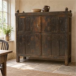 19th century oak hutch cupboard, plank top with moulded cornice and turned finials, panelled front enclosed by two tiers of central double doors with iron hinges and wooden latches, flanked by fixed fielded panels, on stile supports