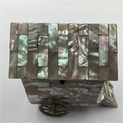 19th century French souvenir jewellery casket in the form of a bathing machine, having mother of pearl panelled tiled effect body, hinged roof/cover revealing a blue silk fitted interior with cushioned base, two silvered metal wheels, abalone shell door and mother of pearl steps, inscribed 'Berck Plage' in blue, H12cm, W13cm 