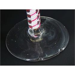 18th century drinking glass, the funnel bowl upon a double series opaque colour twist stem with red and white outer spiral threads around a central tightly twisted column, and circular foot, H13cm, together with another similar 18th century example with trumpet bowl, H11cm