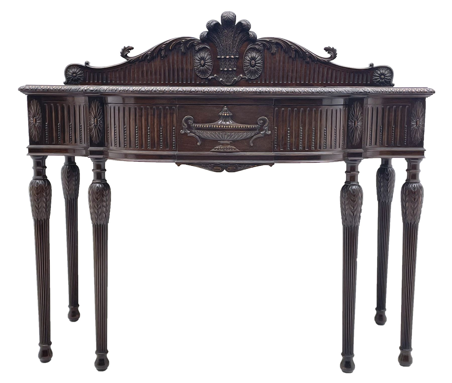 Early 20th century Hepplewhite style serving table, raised fleur-de-lis feather back with fluted detail and flower head mounts, the shaped top with carved foliate edge over single central drawer with applied urn motif, turned and reeded acanthus supports with recessed castors