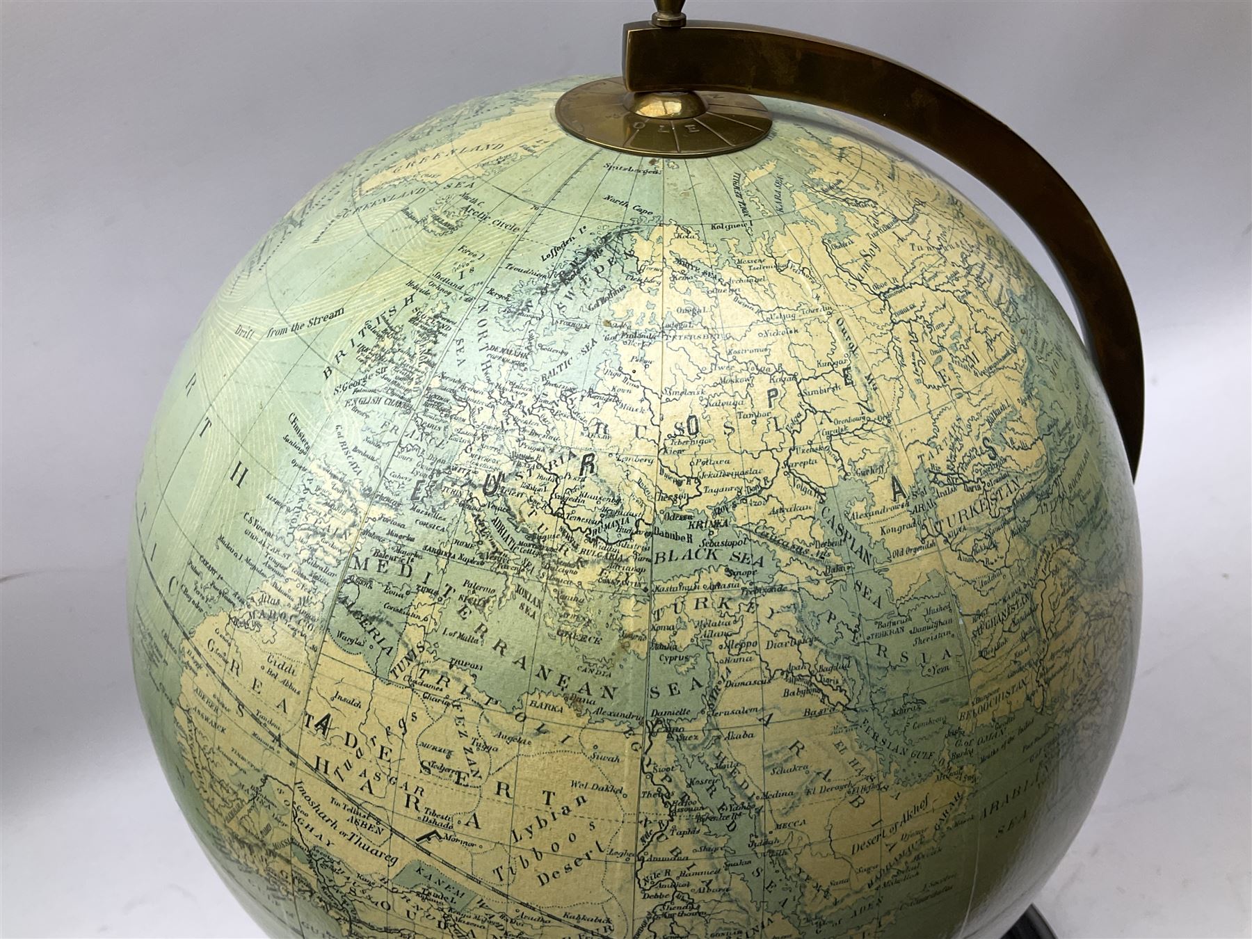 Terrestrial globe by Grinell, Washington, mounted on a brass half meridian and raised on turned wood pedestal base, H55cm
