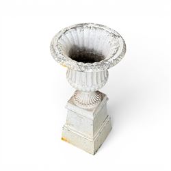 Victorian design white painted cast aluminium garden urn on plinth, fluted bowl on squat pedestal, tapering base