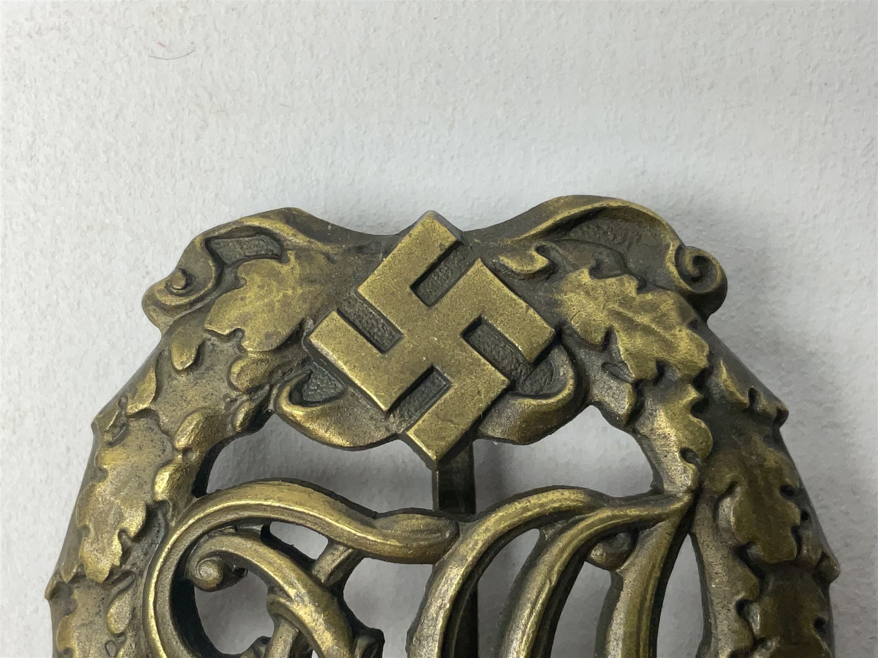 Two WW2 German Sports badges - SA sports badge marked verso 'W.Redo Eigentum D. Obersten SA. Fuhrung Saar Lautern'; and DRL sports badge marked verso 'Wernstein Jena D.R.G.M. 35269' (2)