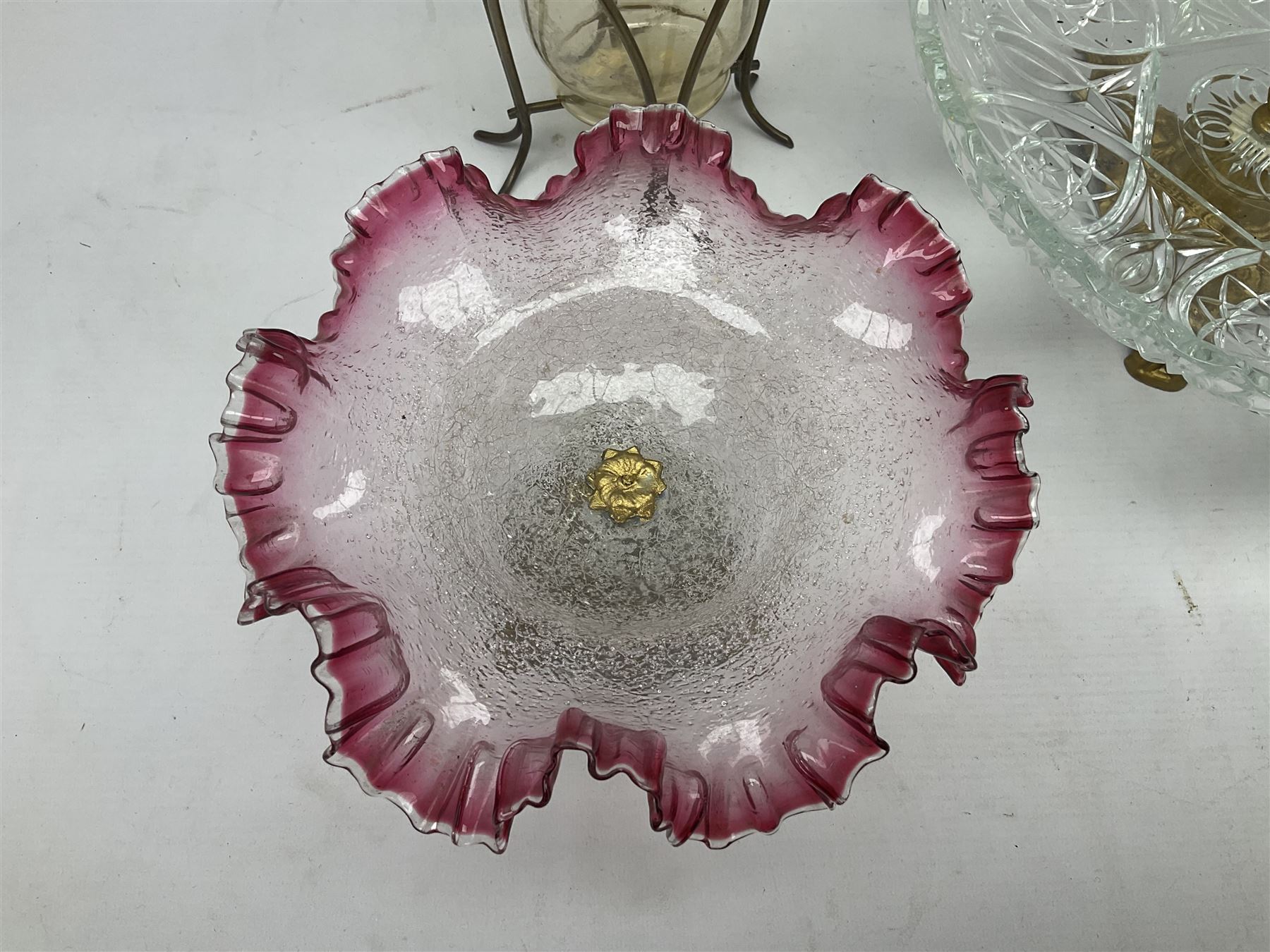 20th century moulded glass and gilt centre piece bowl with carrying handle and ornate trefoil base, together with frilled cranberry edge glass comport with ornate gilt base, and further centre piece with  large glass handle of twisted form, tallest H54cm