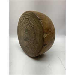 Heavy treen circular block, possibly lignum, the two flat sides carved with bands, possibly a cheese press, H8.5cm, W21.5cm
